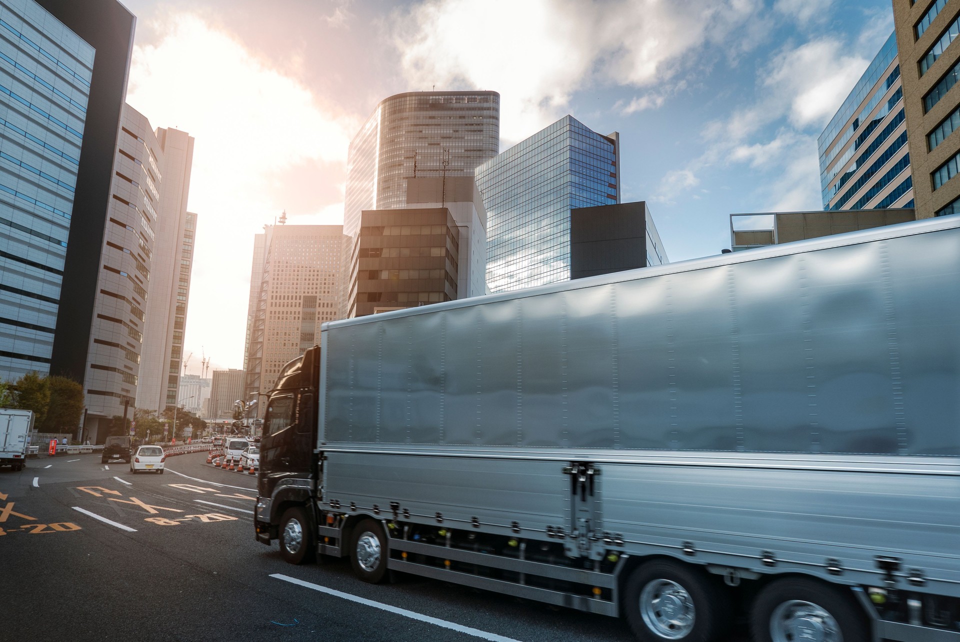 Freight delivery truck driving across the city