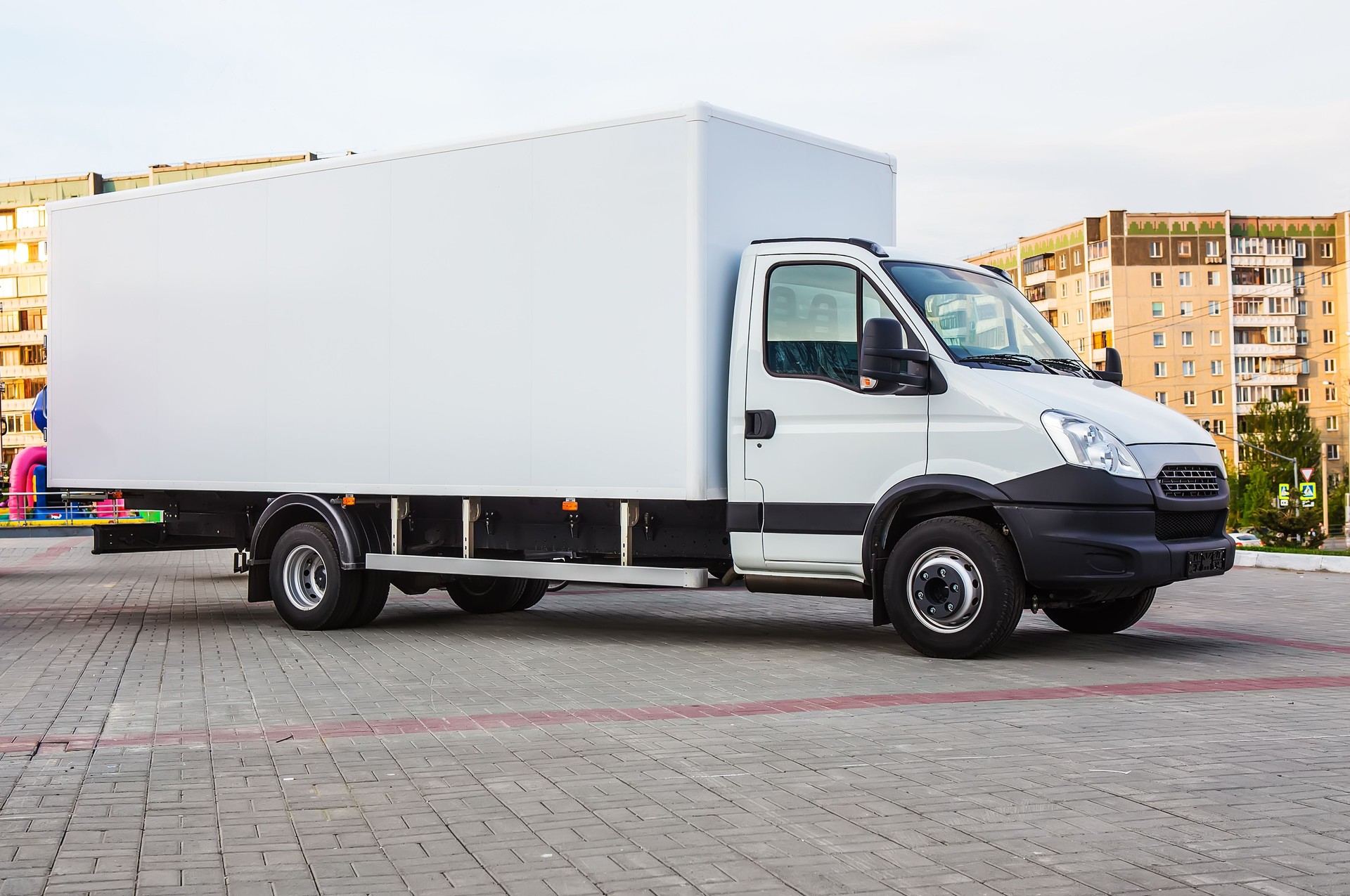 Truck with a container in a residential area of the city.
