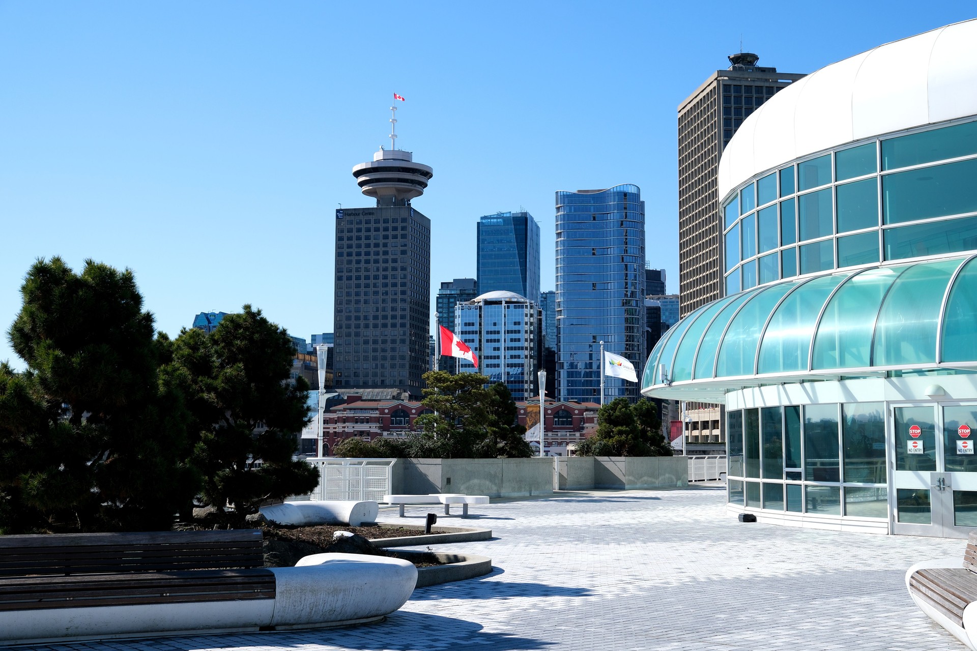 view of canada Place on the embankment different sides of a beautiful city skyscrapers big ships flag planes mountains a city everything expensive luxury vacation trip travel glass building offices
